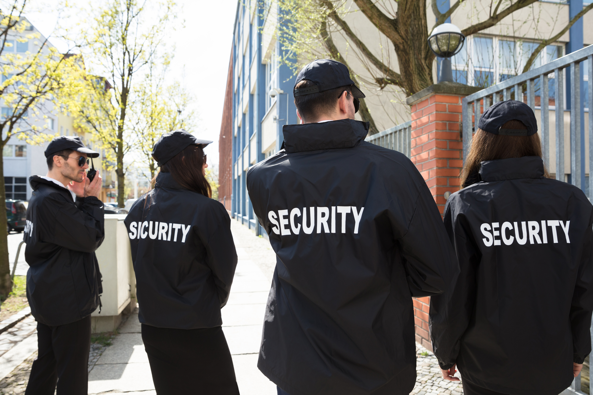 Rear View Of Security Guards In Black Uniform